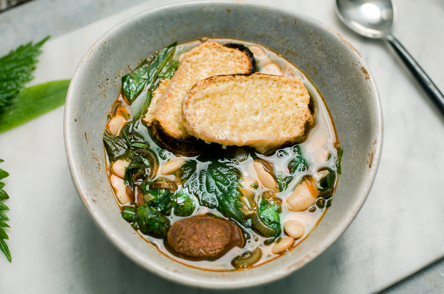 Wild garlic, nettle and chorizo soup with Butter beans, toasted sourdough and Barber's cheddar