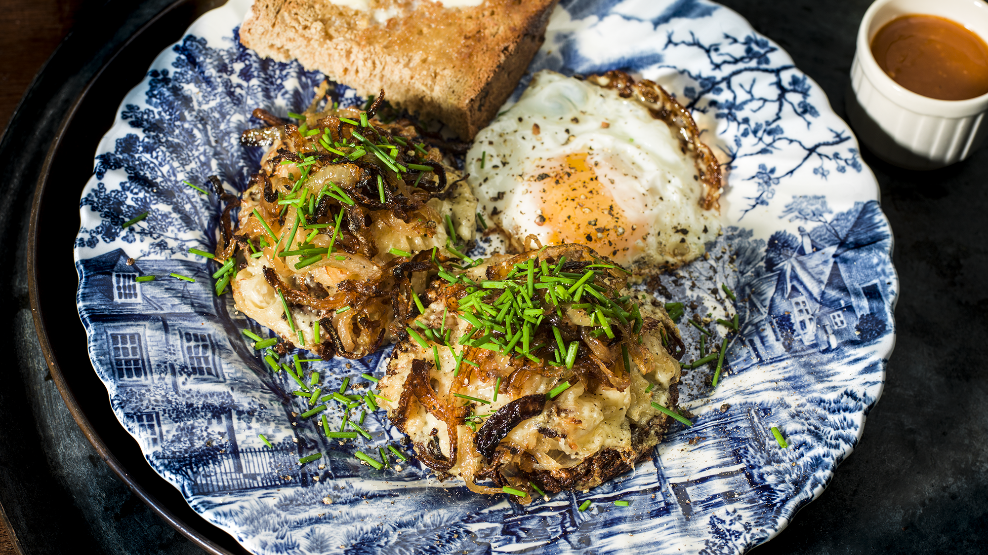 Potato röstis with sauerkraut, fried onions and Barbers 1833 cheddar by Gill Meller
